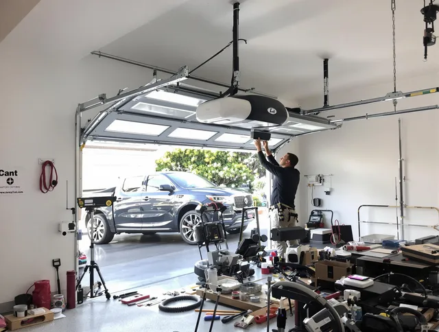 Redlands Garage Door Repair specialist installing smart garage door opener system in Redlands home